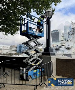 a man on a Electric Scissor Lift Construction Project